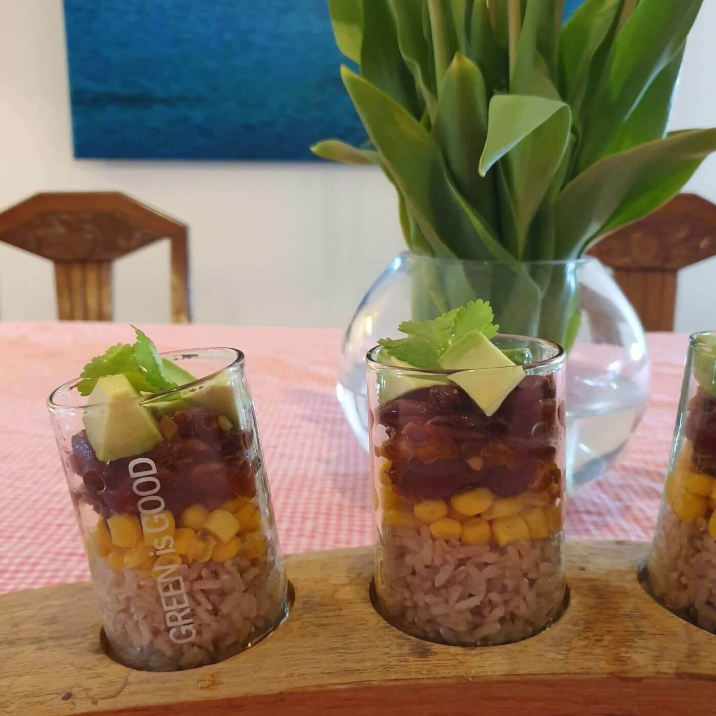 A table with three glasses filled with food.